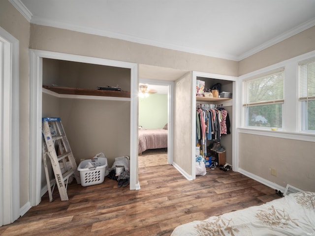 bedroom with wood-type flooring, a closet, and ornamental molding