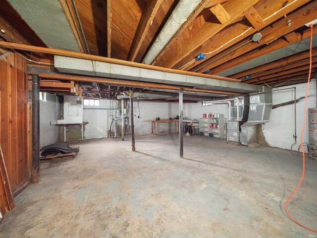 basement with gas water heater and heating unit