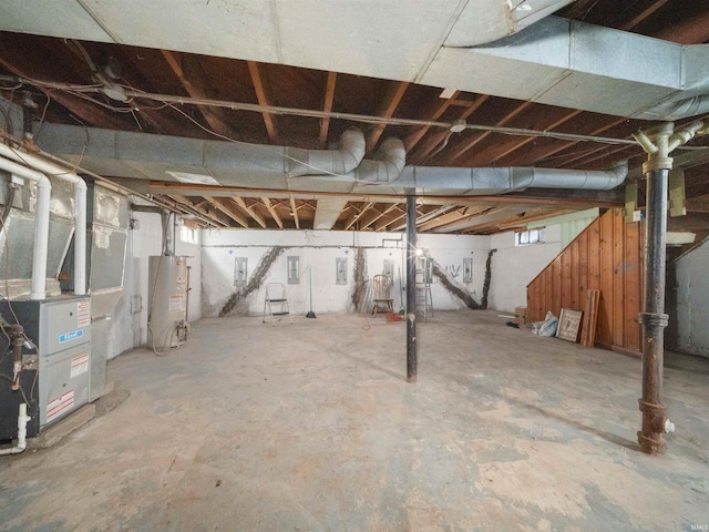 basement with water heater and heating unit