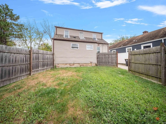 rear view of house featuring a lawn