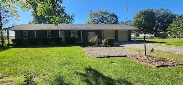 ranch-style house featuring a garage, covered porch, and a front yard