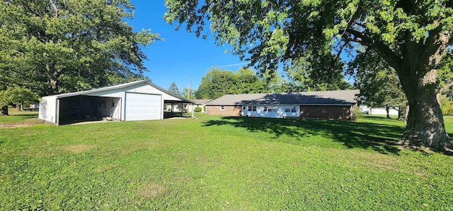 view of yard featuring an outdoor structure and a carport