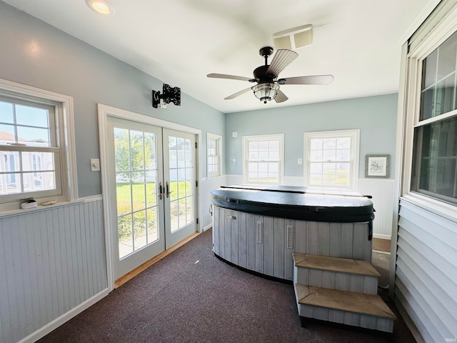 interior space featuring french doors, plenty of natural light, a jacuzzi, and ceiling fan