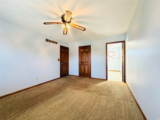 unfurnished bedroom featuring connected bathroom, carpet, and ceiling fan