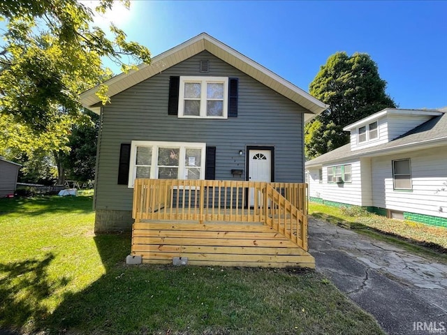 view of front of house with a deck and a front lawn