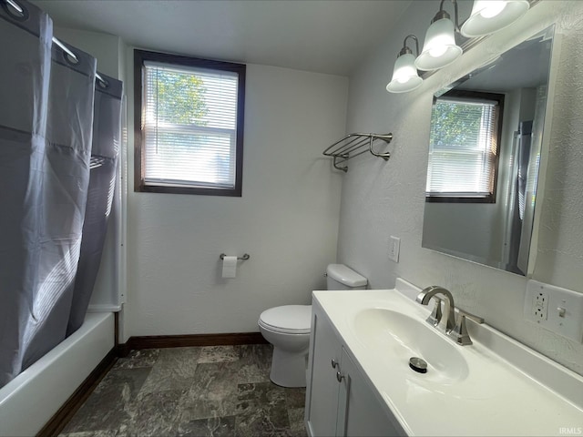 full bathroom with a healthy amount of sunlight, vanity, toilet, and shower / bath combo with shower curtain