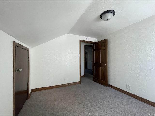 bonus room featuring lofted ceiling and light carpet