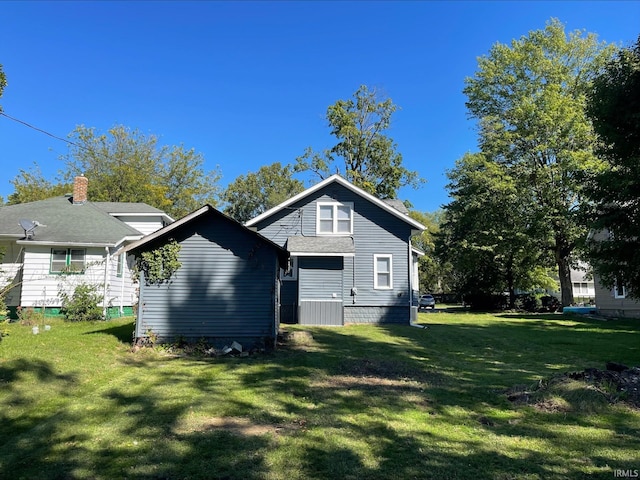 rear view of house with a yard