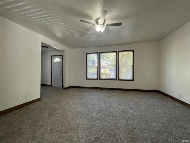 spare room featuring carpet flooring and ceiling fan