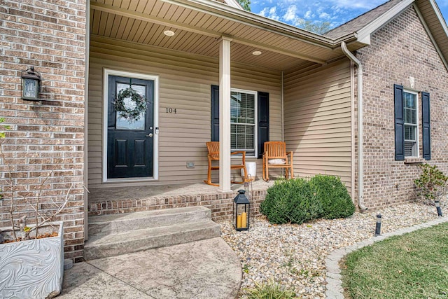 view of exterior entry with covered porch