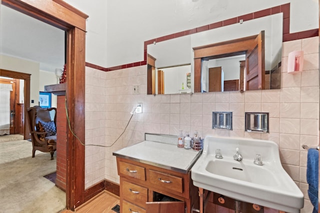 bathroom featuring tile walls, hardwood / wood-style floors, and sink