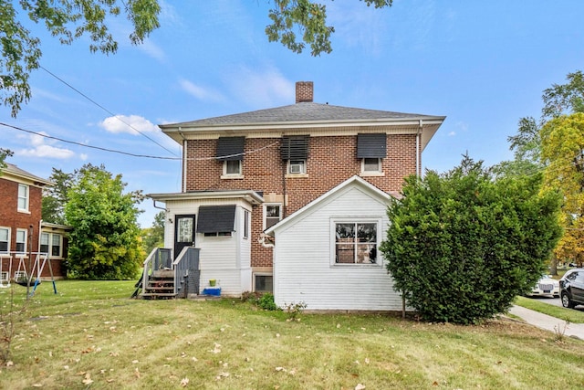 rear view of property featuring a yard