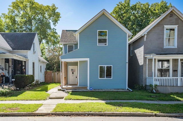 view of front of home with a porch and a front yard