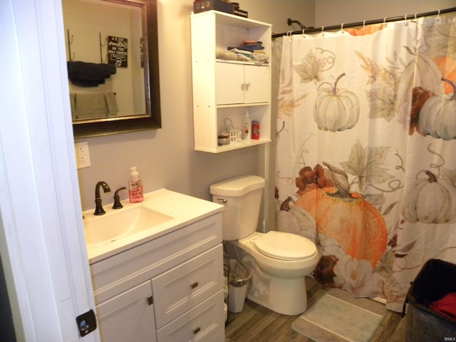 bathroom with vanity, toilet, a shower with shower curtain, and hardwood / wood-style flooring