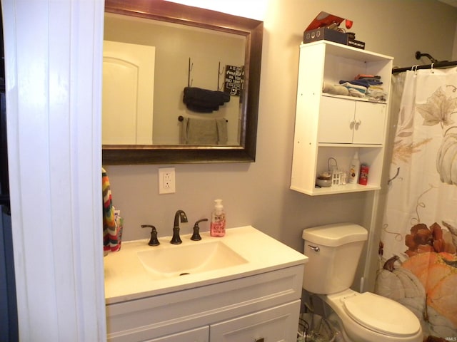 bathroom featuring vanity, toilet, and a shower with shower curtain