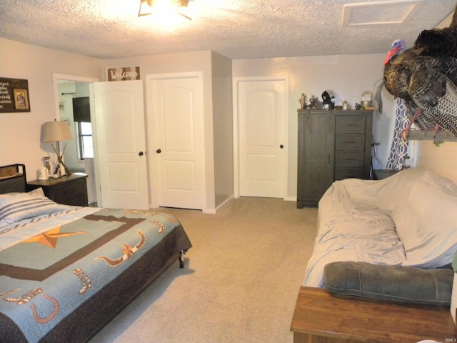 bedroom featuring light carpet and a textured ceiling