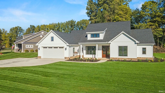 modern inspired farmhouse with a front lawn and a garage