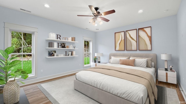 bedroom featuring ceiling fan and light hardwood / wood-style flooring