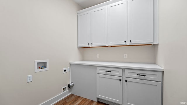 laundry room featuring hookup for a washing machine, hookup for an electric dryer, light hardwood / wood-style flooring, and cabinets