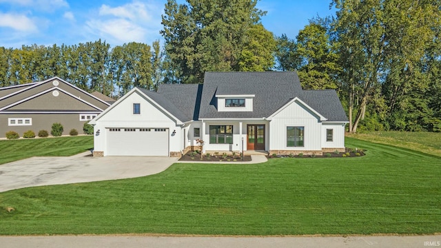 modern farmhouse style home featuring a front lawn, covered porch, and a garage