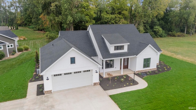 view of front of property with a front yard and a garage