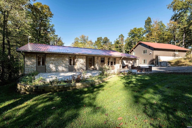 rear view of house with a lawn and a patio