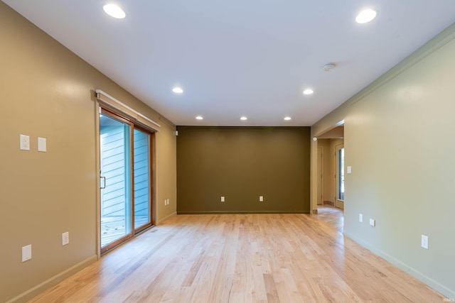 spare room with light hardwood / wood-style flooring and ornamental molding