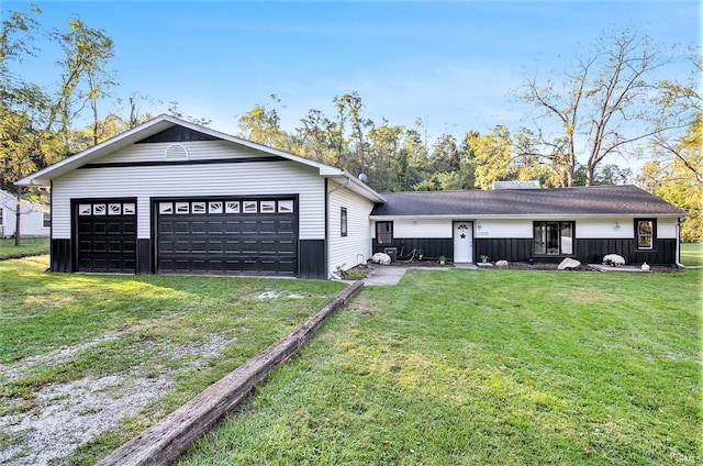 view of front of home featuring a garage and a front yard