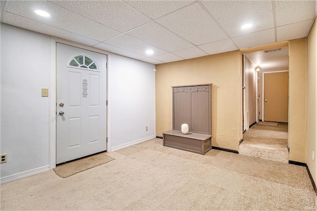 carpeted foyer entrance featuring a paneled ceiling