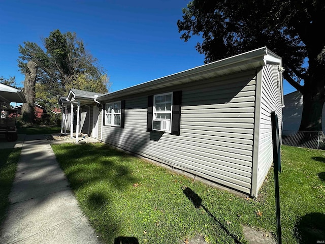 view of side of home featuring a lawn