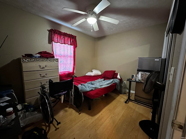 bedroom with light hardwood / wood-style floors and ceiling fan