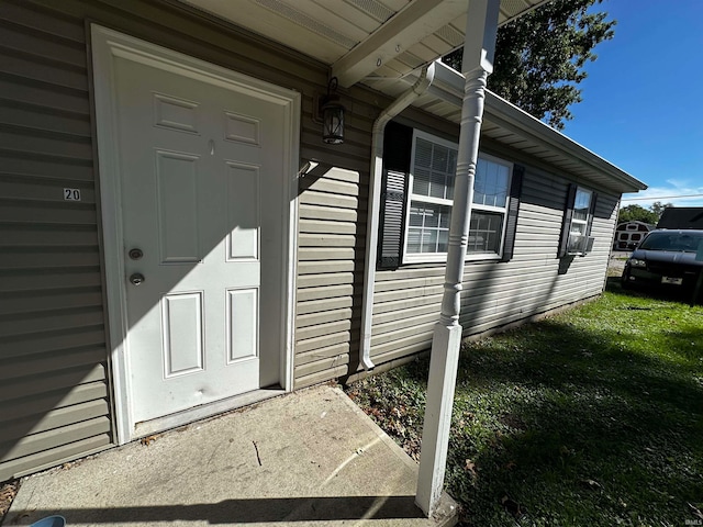 doorway to property with a yard