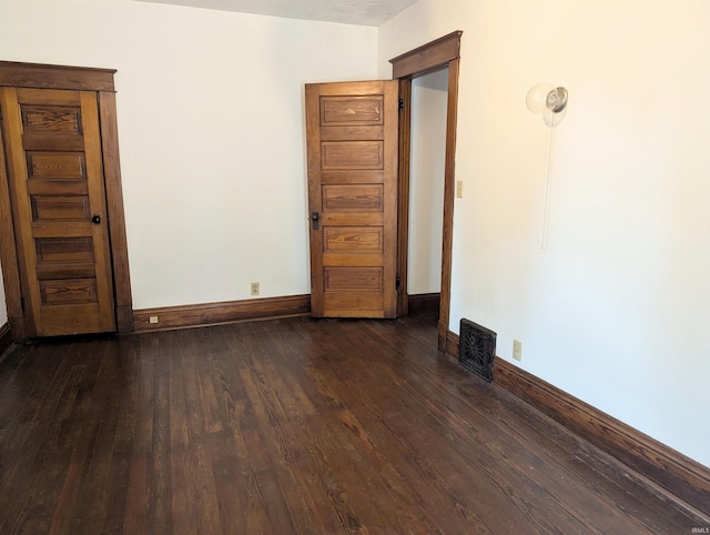 unfurnished room featuring dark hardwood / wood-style floors