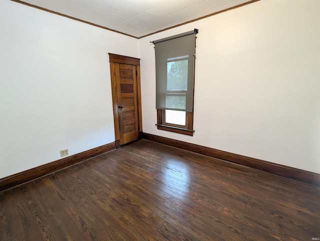 unfurnished room with crown molding and dark hardwood / wood-style flooring