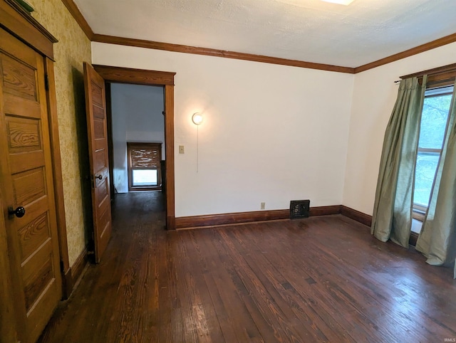 empty room with crown molding and dark wood-type flooring