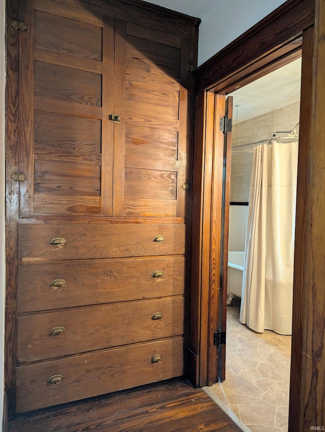 hallway with hardwood / wood-style flooring