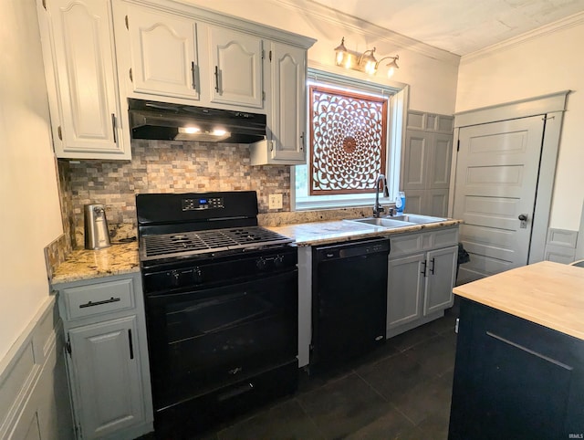 kitchen with dark tile patterned flooring, sink, white cabinetry, black appliances, and crown molding