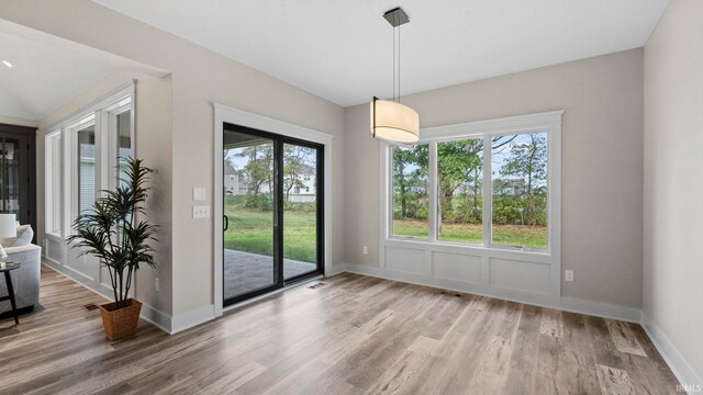 unfurnished dining area featuring hardwood / wood-style flooring