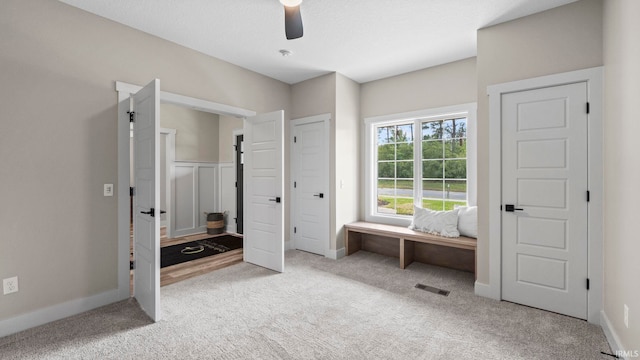 unfurnished bedroom featuring ceiling fan and light colored carpet