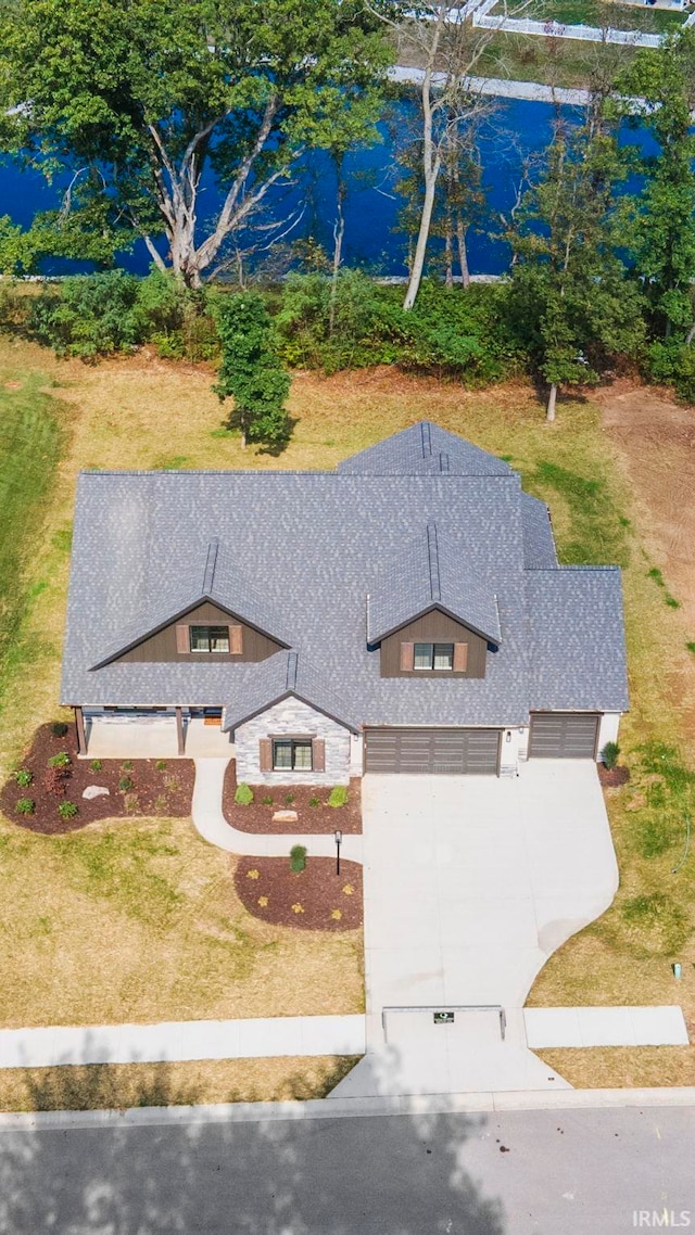 birds eye view of property with a water view