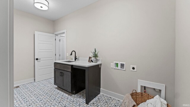 washroom with washer hookup, cabinets, sink, and hookup for an electric dryer