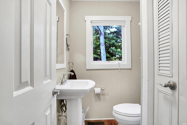 bathroom featuring hardwood / wood-style floors and toilet