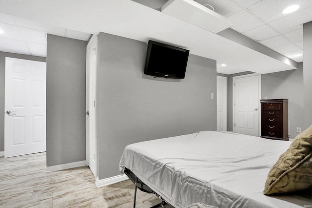 bedroom with light wood-type flooring, pool table, and a paneled ceiling