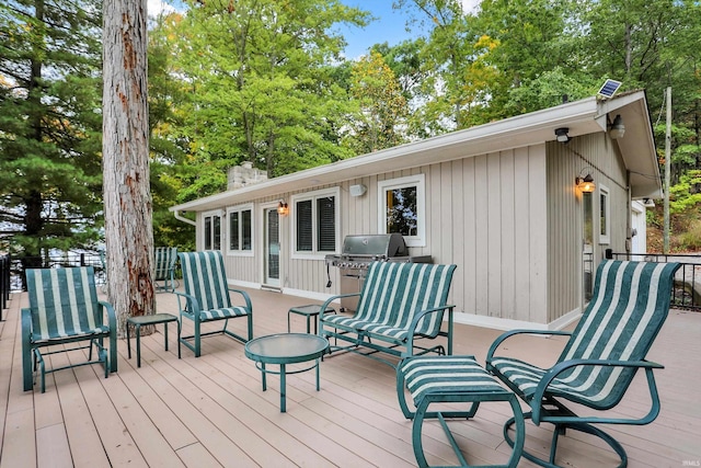 wooden deck with a grill