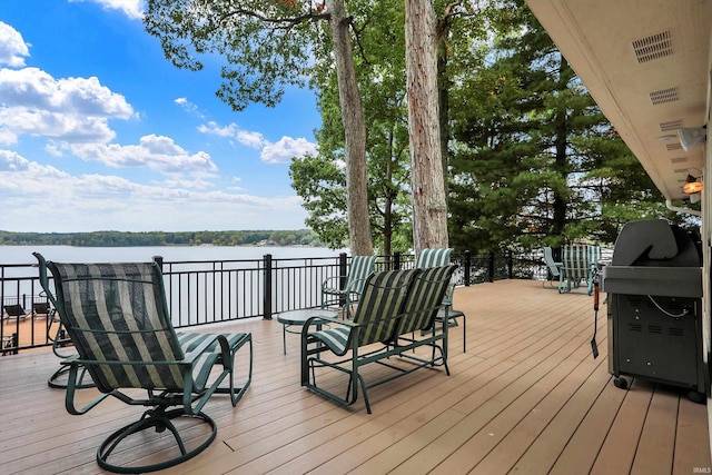 wooden deck featuring a water view