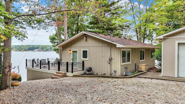 exterior space featuring a deck with water view and central AC