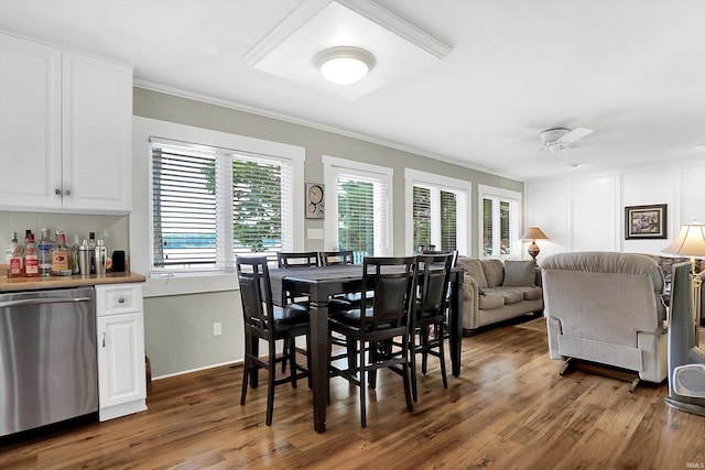 dining space with ceiling fan, dark hardwood / wood-style floors, and a healthy amount of sunlight