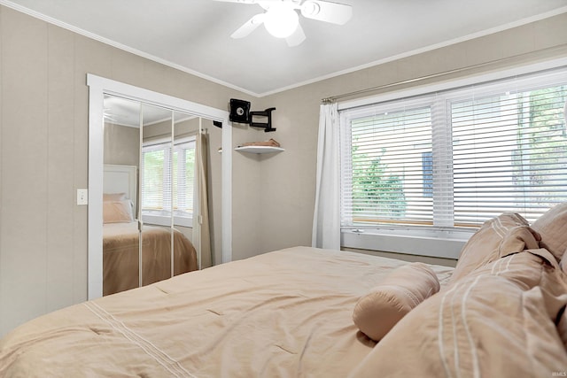 bedroom featuring ornamental molding, a closet, multiple windows, and ceiling fan