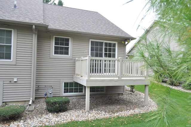 back of property featuring a wooden deck