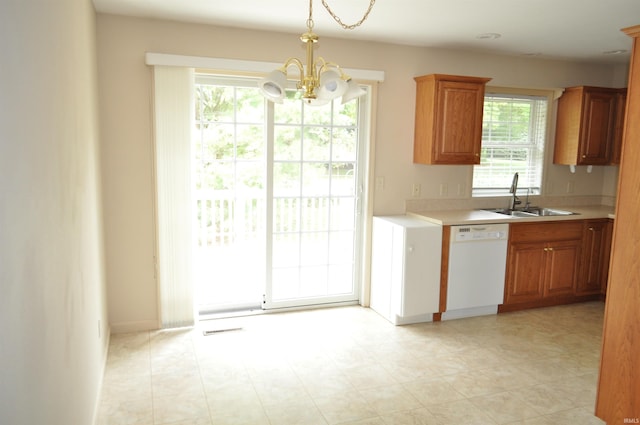 kitchen featuring a notable chandelier, dishwasher, sink, and a wealth of natural light